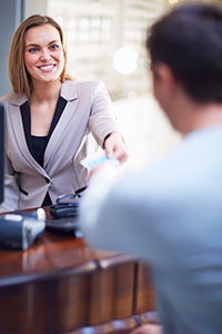 Branch employee smiling at customer-ATM service